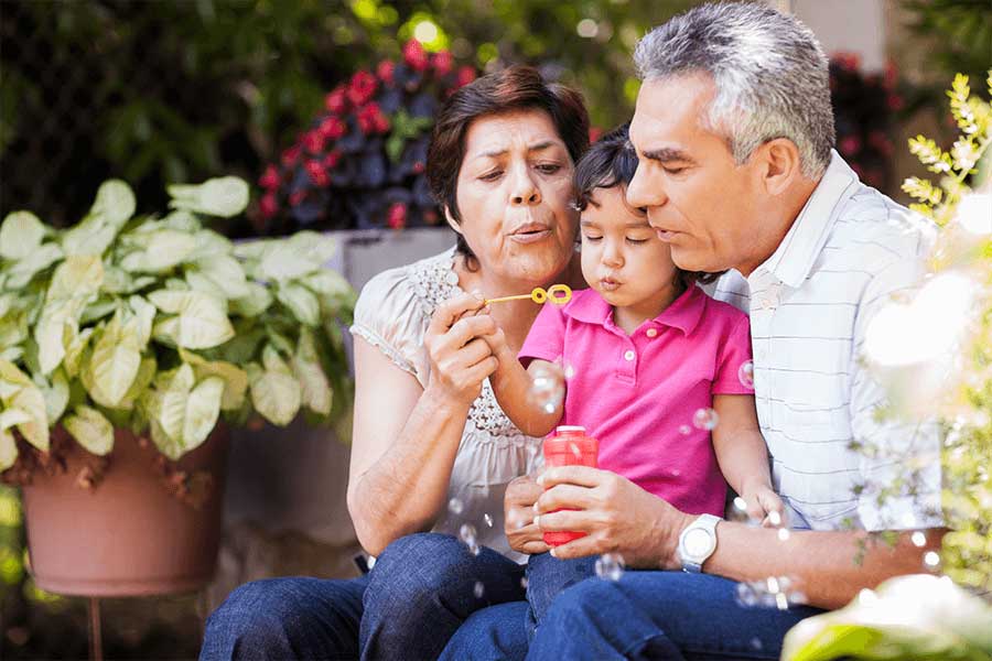 family blowing bubbles