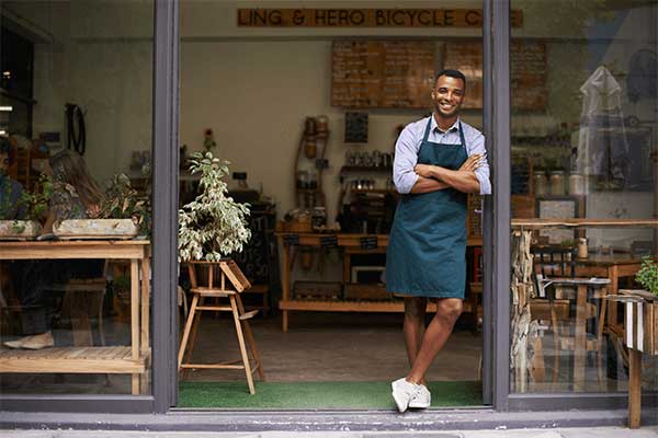 man in front of small business