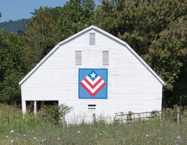 white barn with quilt