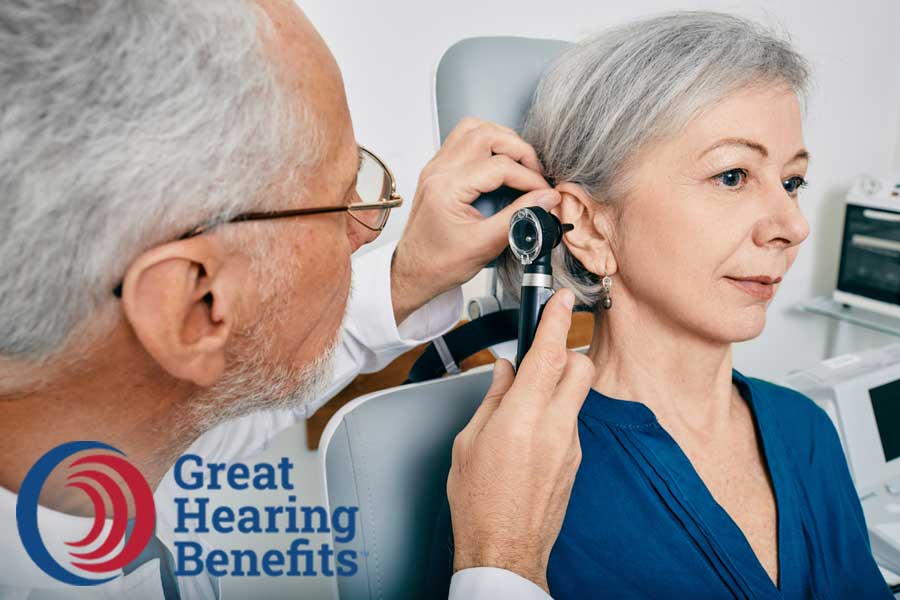 Hearing professional looking in woman's ear