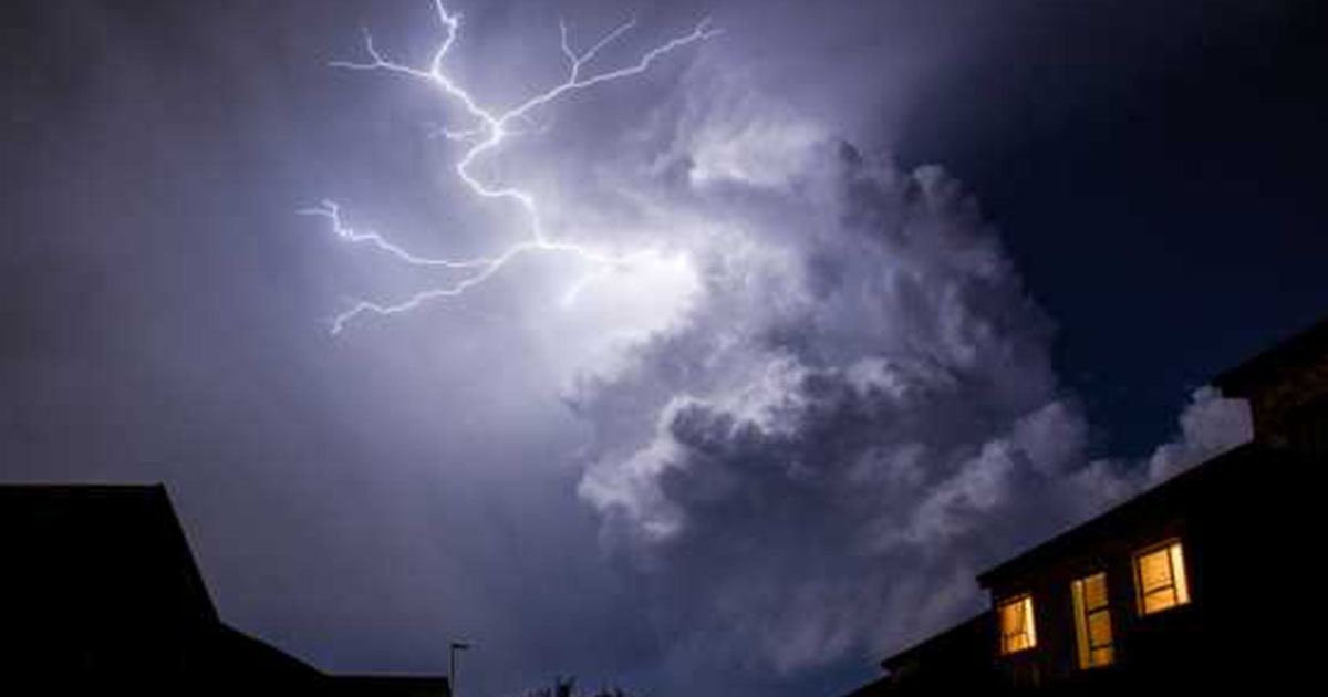 Lightning over homes at night