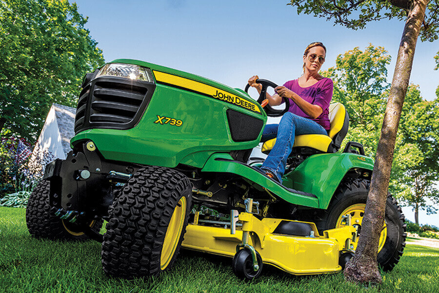 Woman riding John Deere tractor